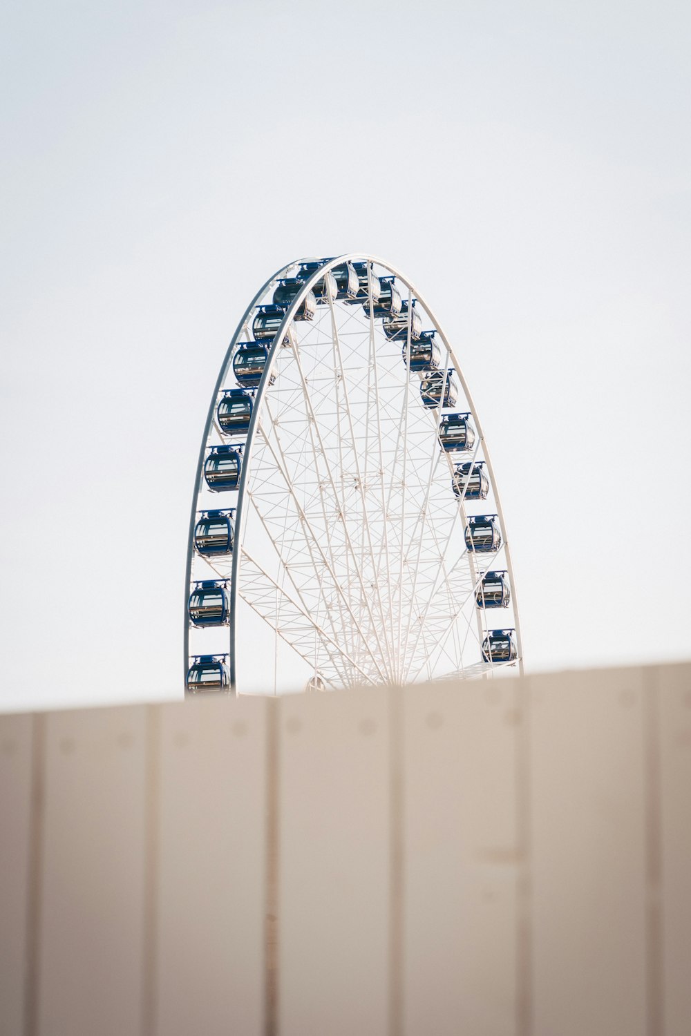 white ferris wheel under white sky