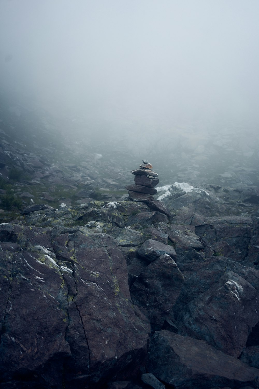 person sitting on rock formation during daytime