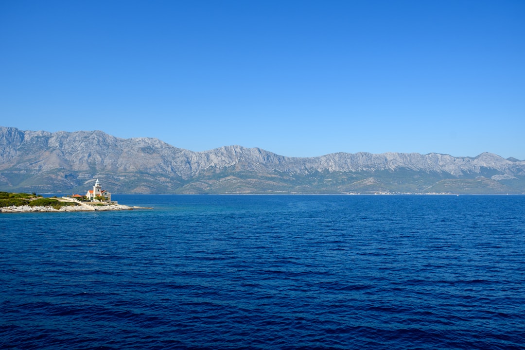 white and yellow boat on sea during daytime