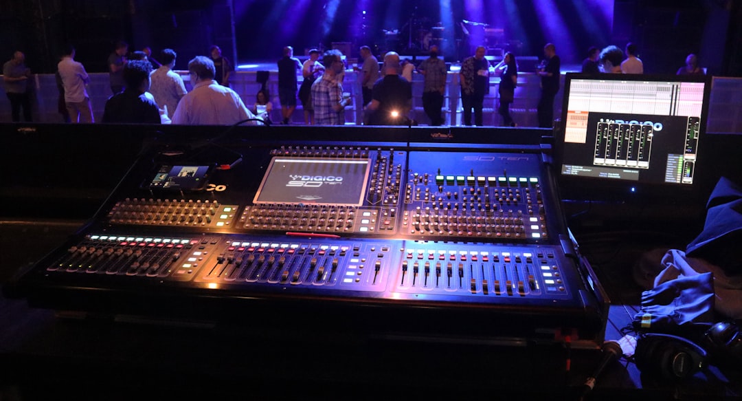 people sitting on chair in front of audio mixer