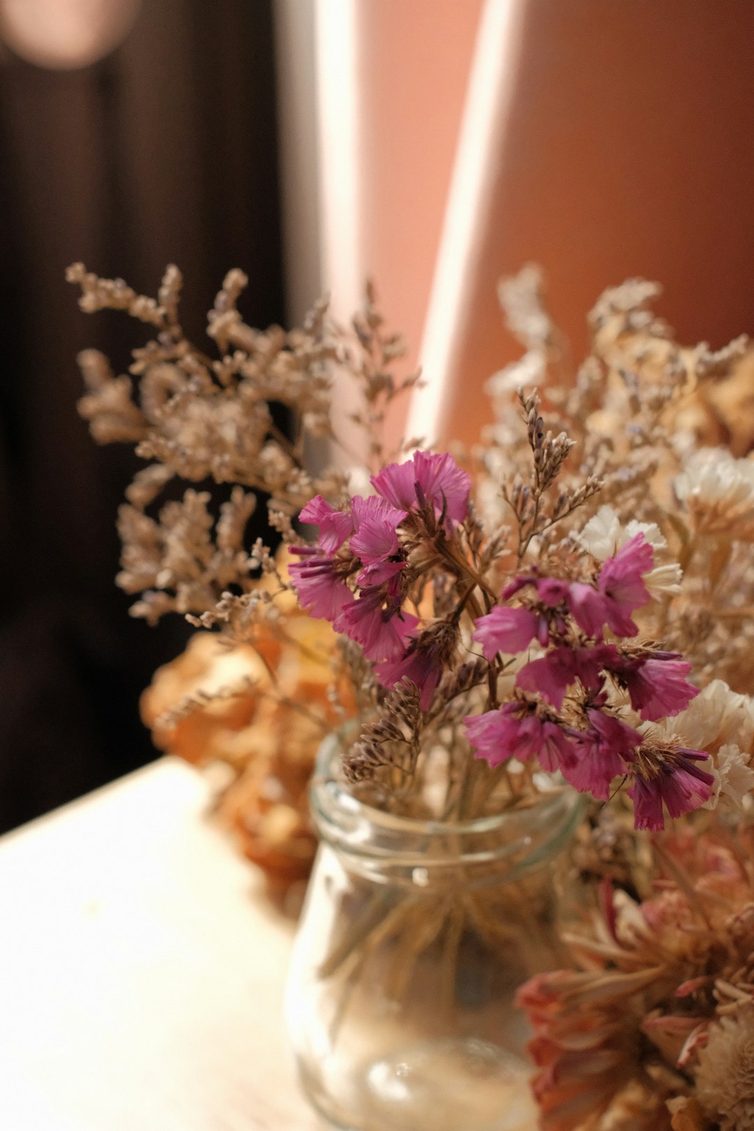 purple flowers in clear glass jar