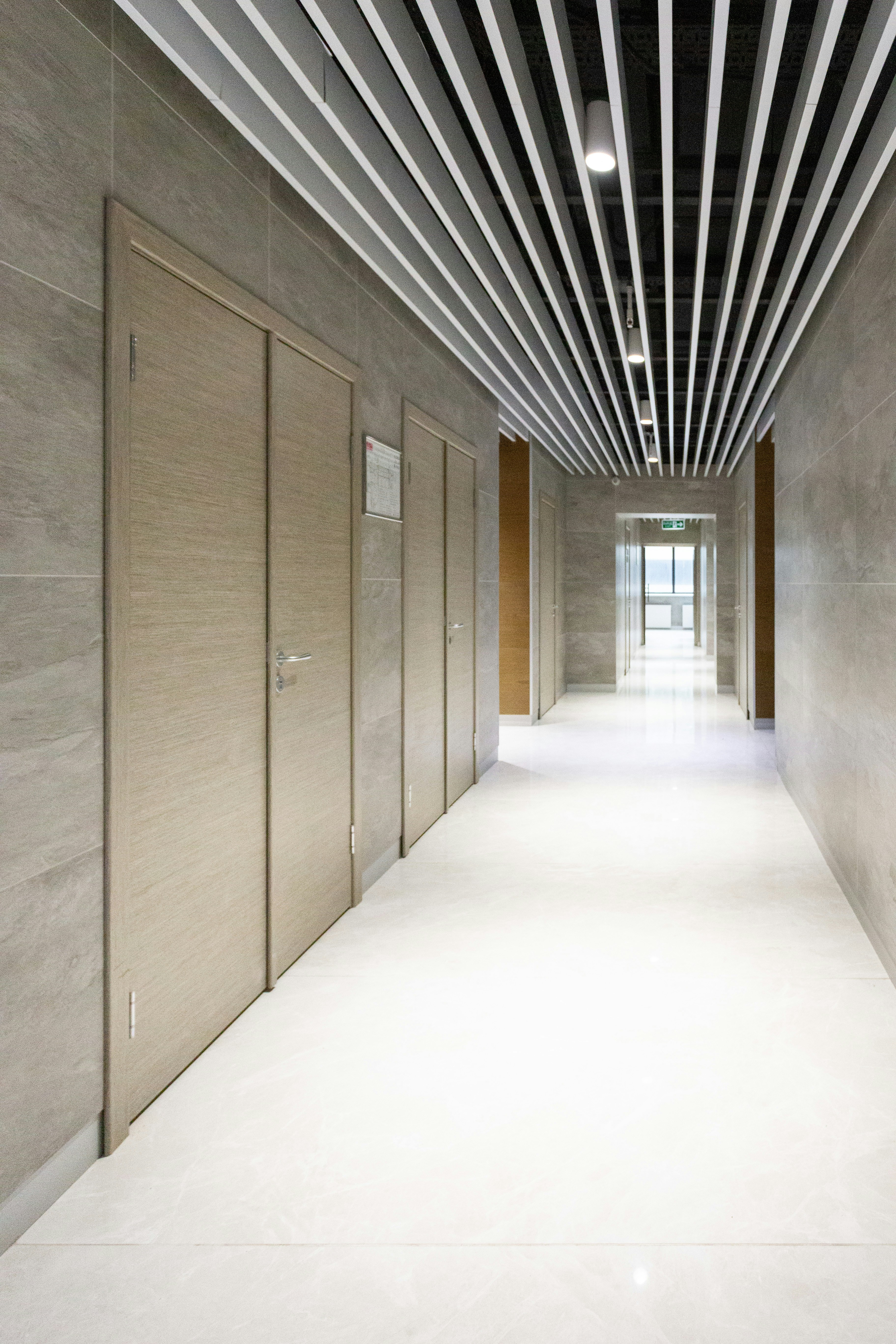 brown wooden doors on white concrete wall