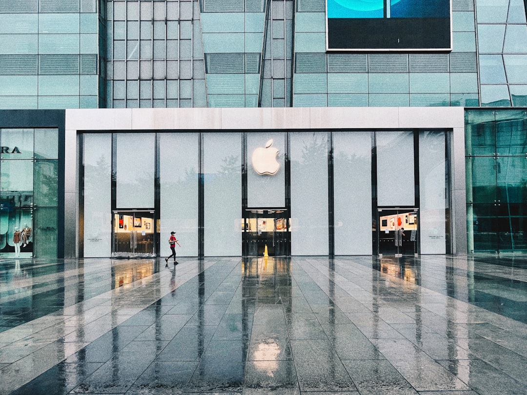 person in black jacket standing in front of glass window