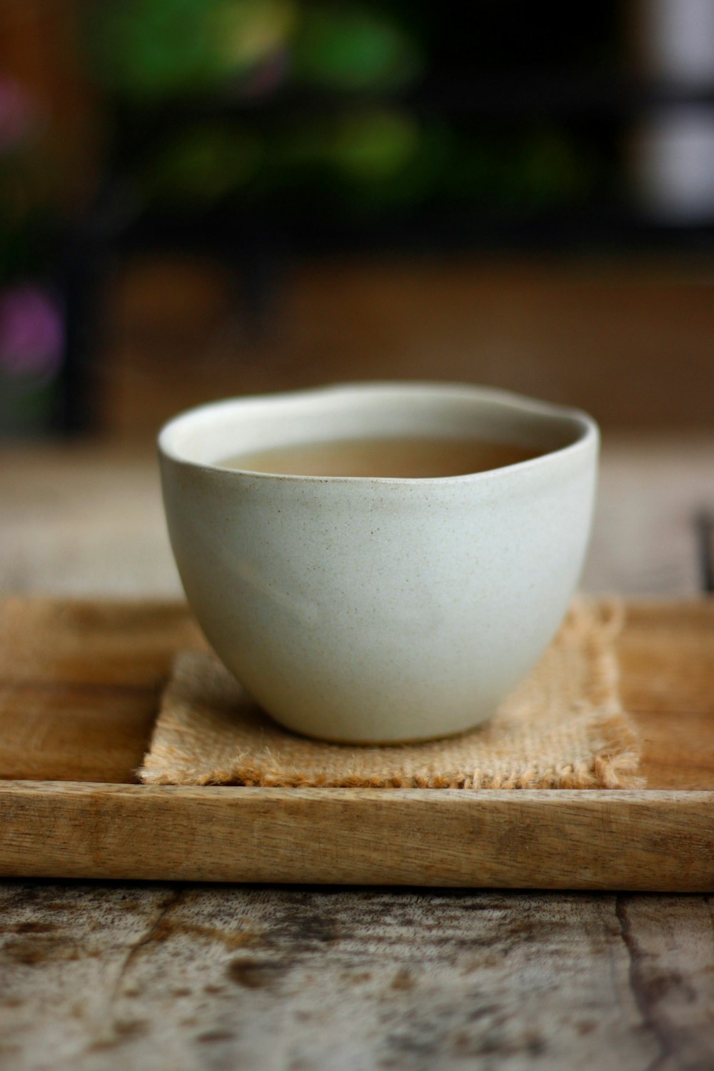 white ceramic cup on brown wooden table