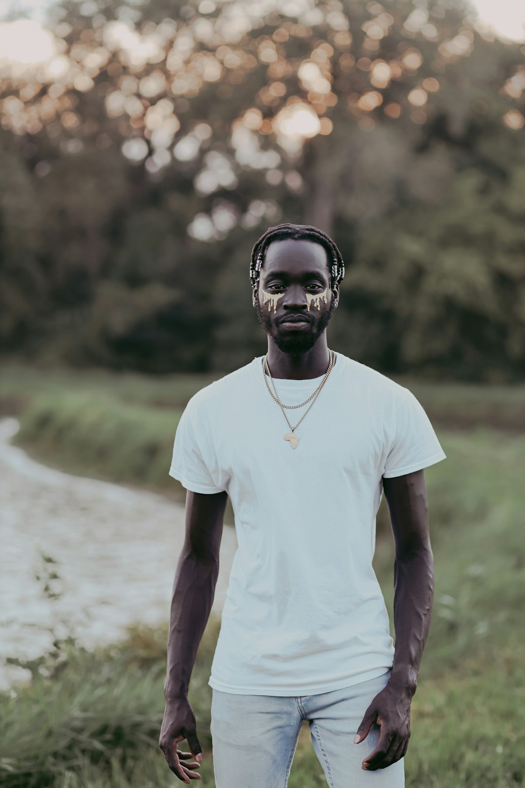 man in white crew neck t-shirt standing near body of water during daytime