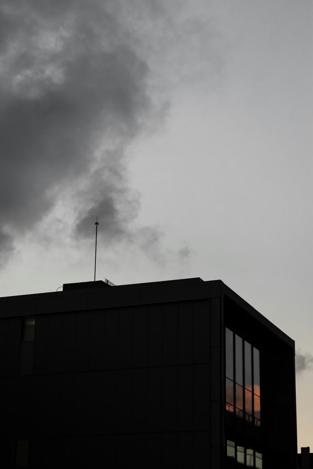 black concrete building under gray clouds