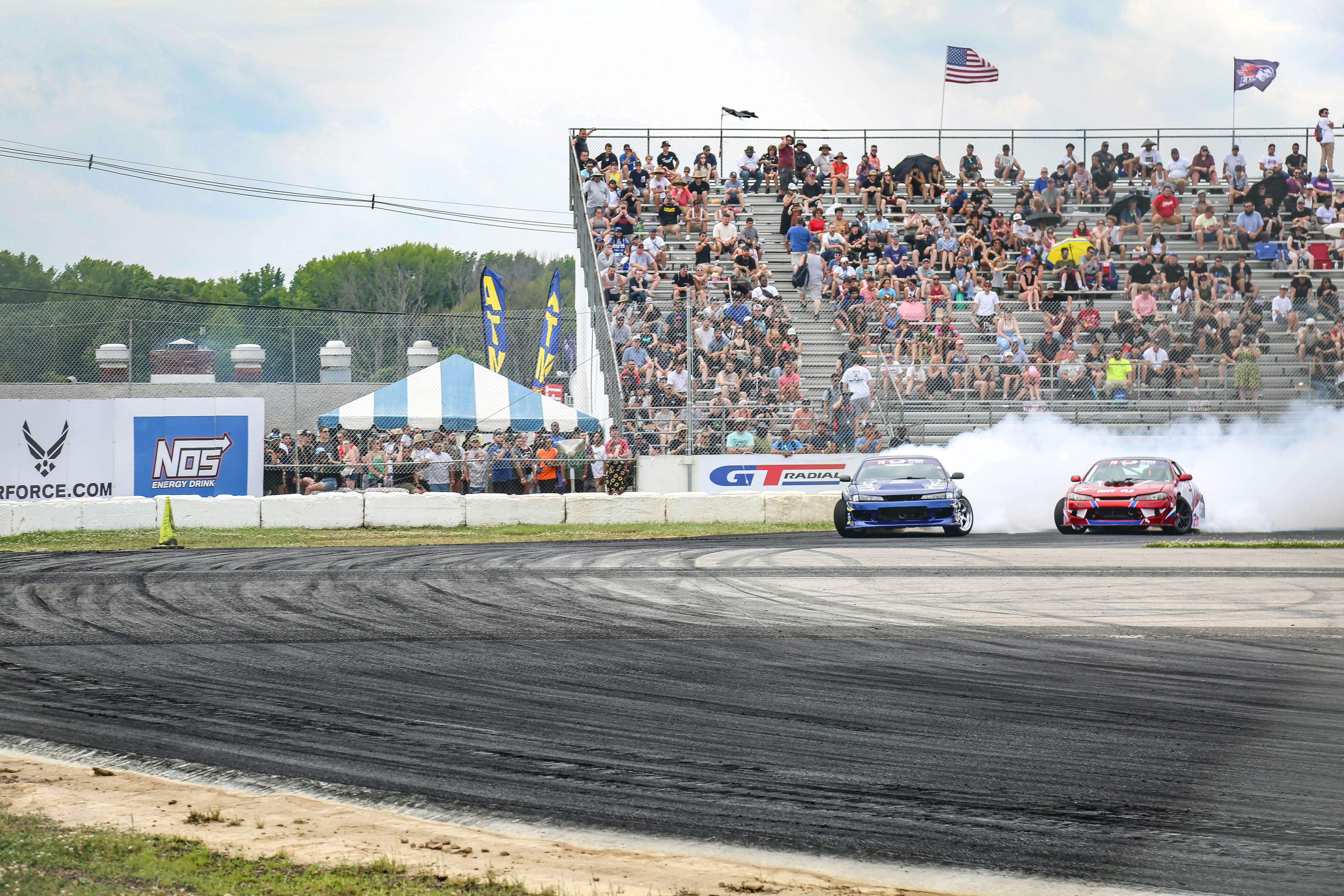 white and black racing car on track during daytime