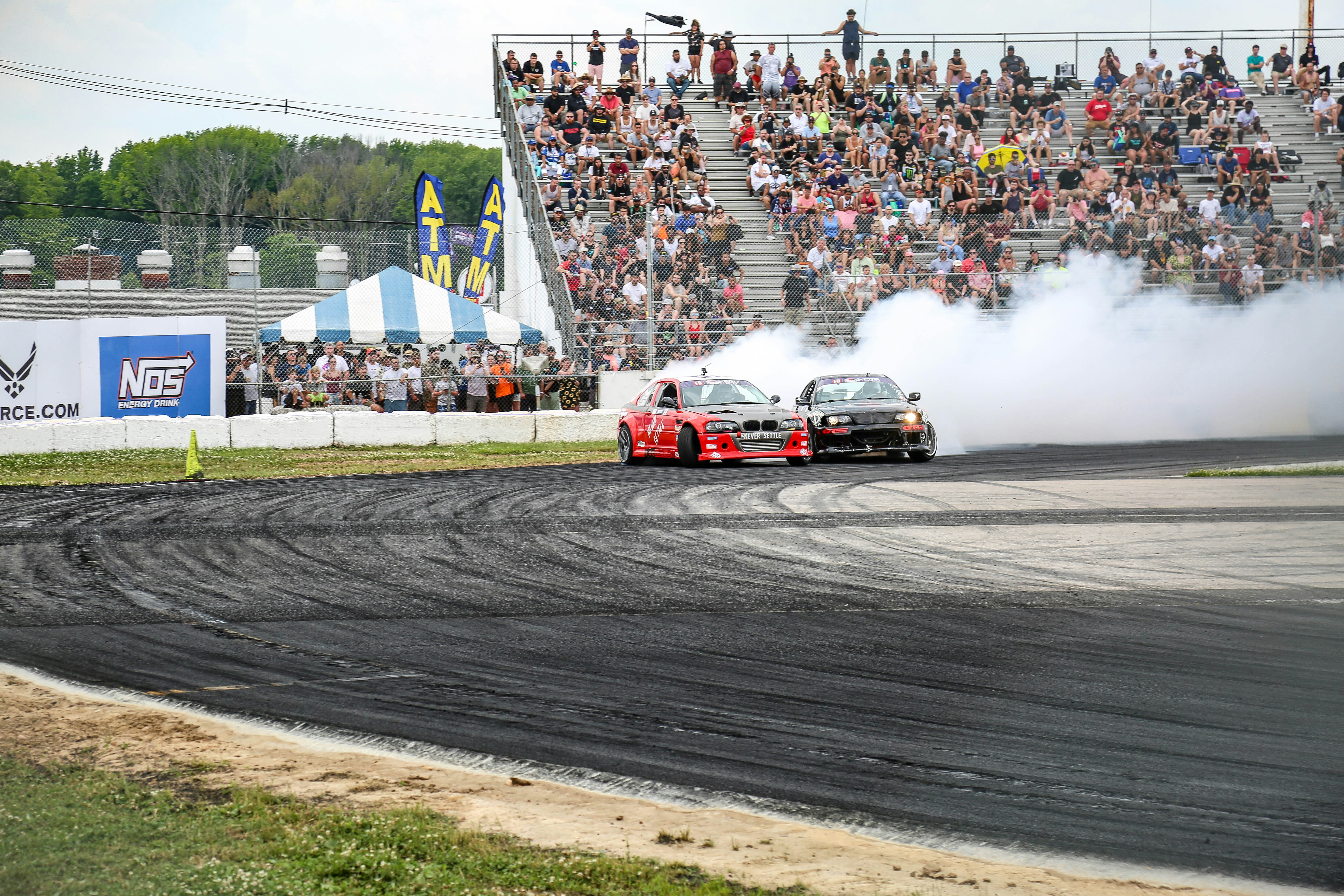 red and white racing car on track during daytime