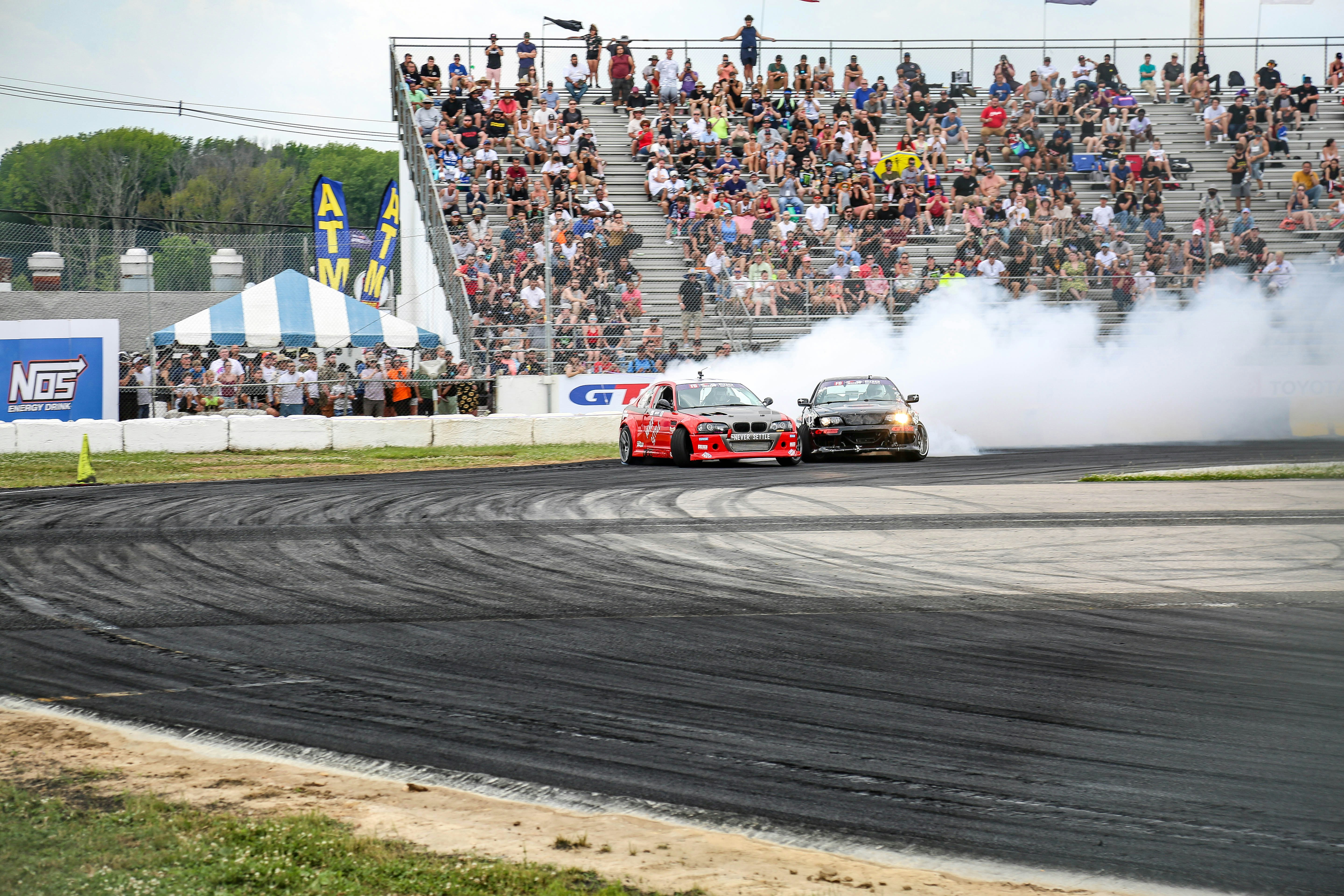 red and white racing car on race track during daytime