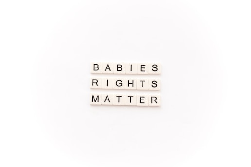 Tile letters arranged to form the words 'BABIES RIGHTS MATTER' on a white background.