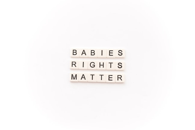 Tile letters arranged to form the words 'BABIES RIGHTS MATTER' on a white background.