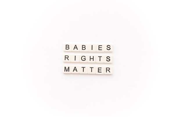 Tile letters arranged to form the words 'BABIES RIGHTS MATTER' on a white background.