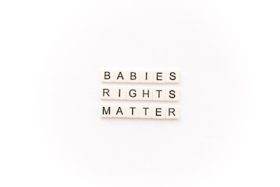 Tile letters arranged to form the words 'BABIES RIGHTS MATTER' on a white background.