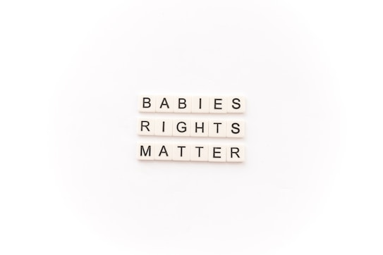 Tile letters arranged to form the words 'BABIES RIGHTS MATTER' on a white background.