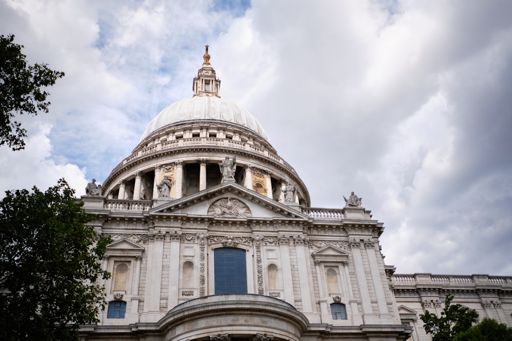 white concrete dome building under white clouds during daytime