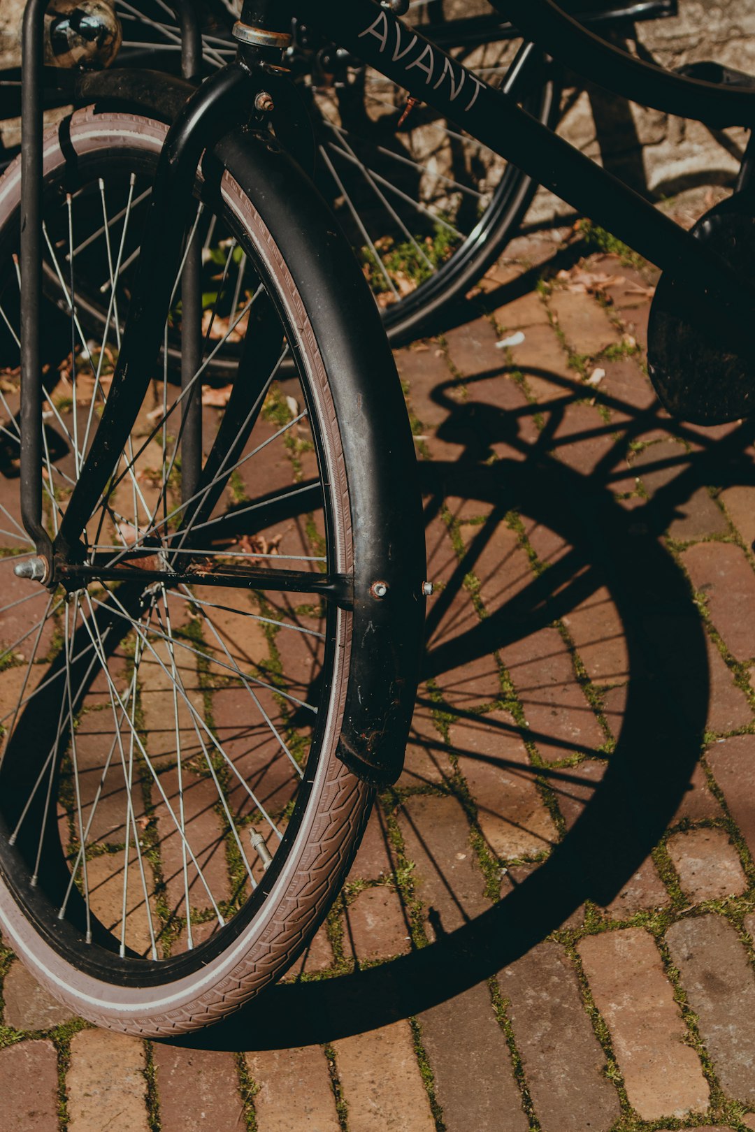 black bicycle wheel on gray concrete floor