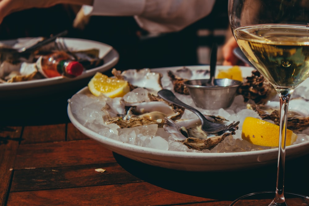 white ceramic plate with food on brown wooden table