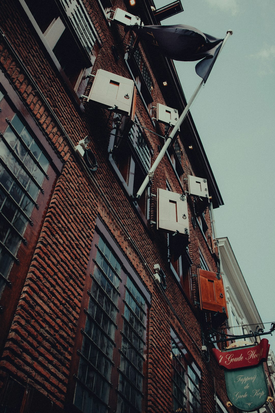 brown brick building under gray sky