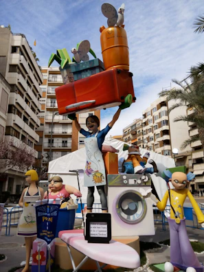 A funny parenting cartoon showing a dad juggling chores and kids.