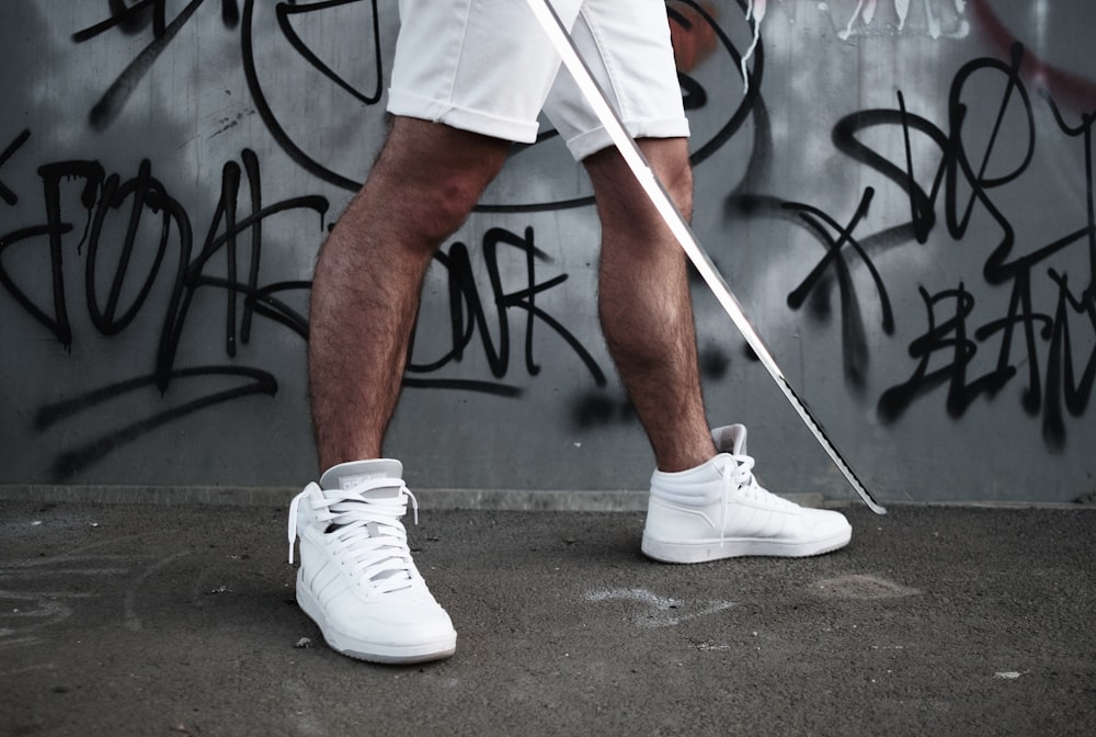 man in white nike shoes playing basketball