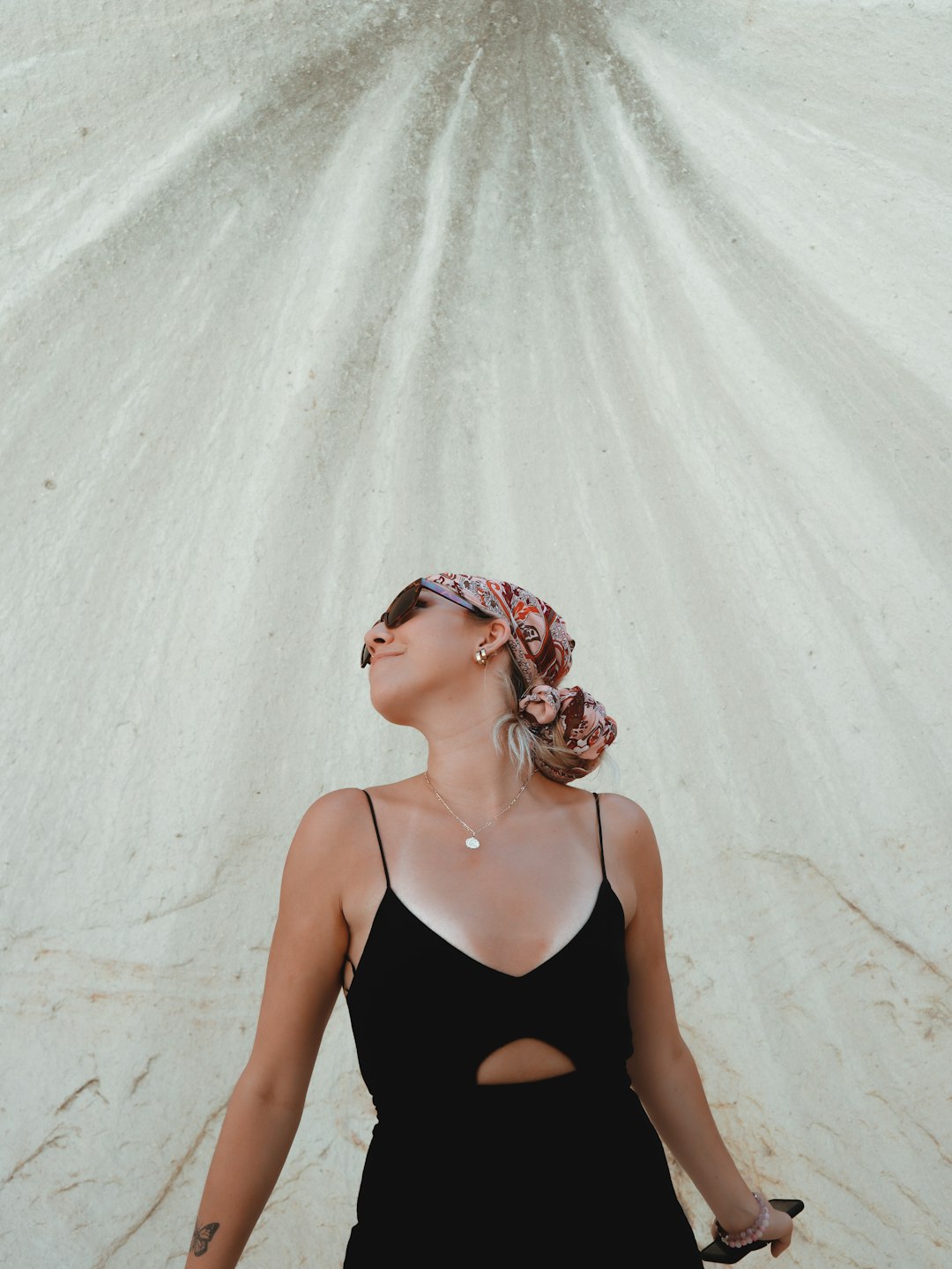 woman in black tank top wearing pink floral head band