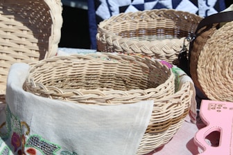 brown woven basket on gray textile