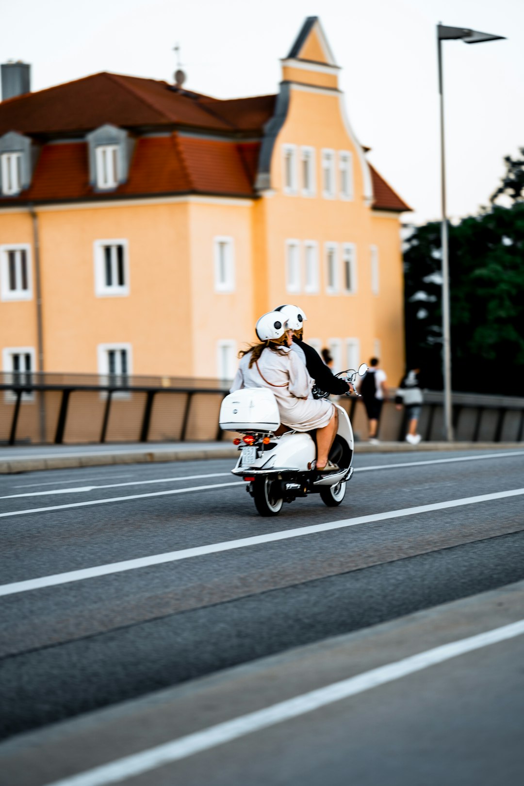 man in white helmet riding on motorcycle on road during daytime