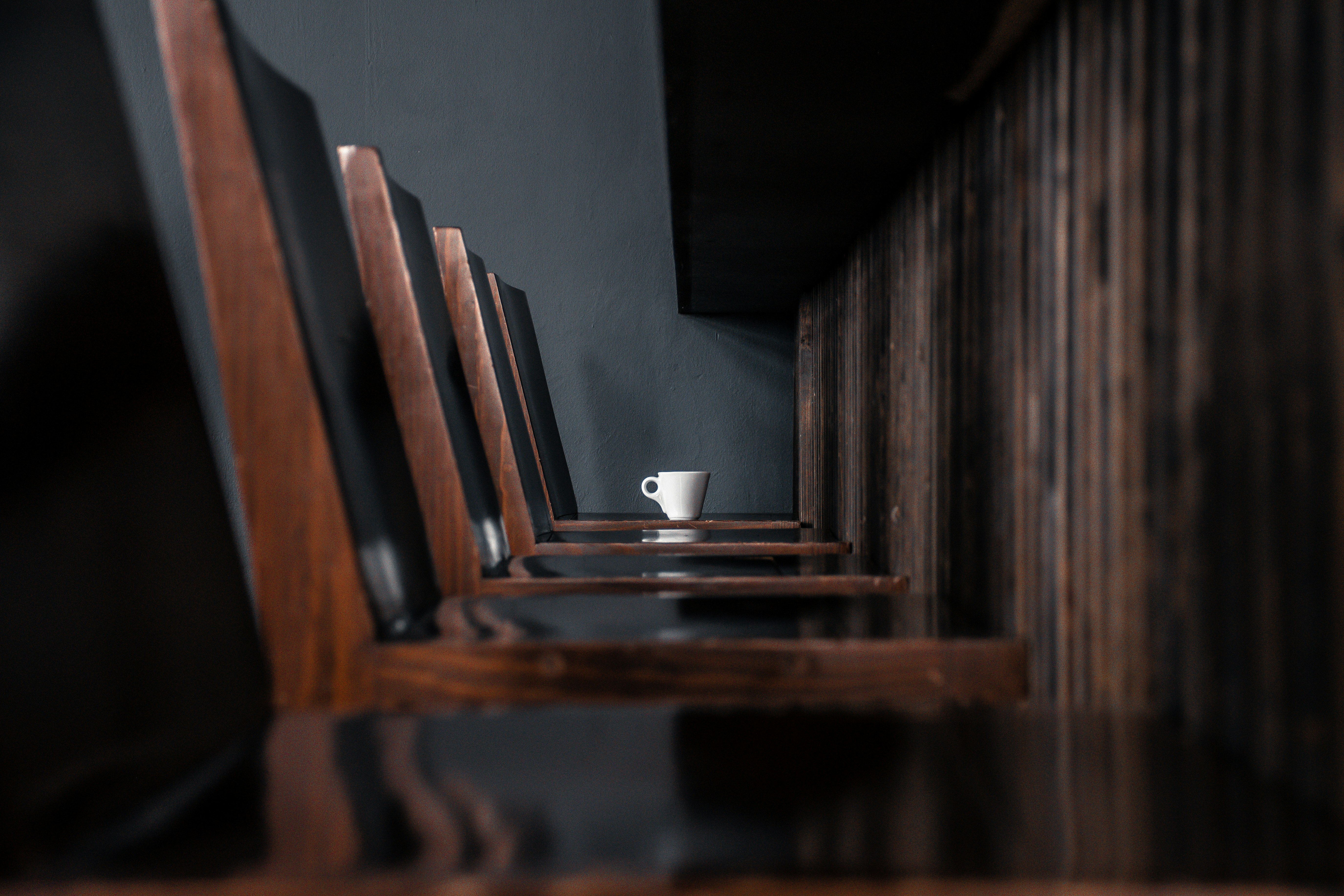 white ceramic cup on brown wooden table