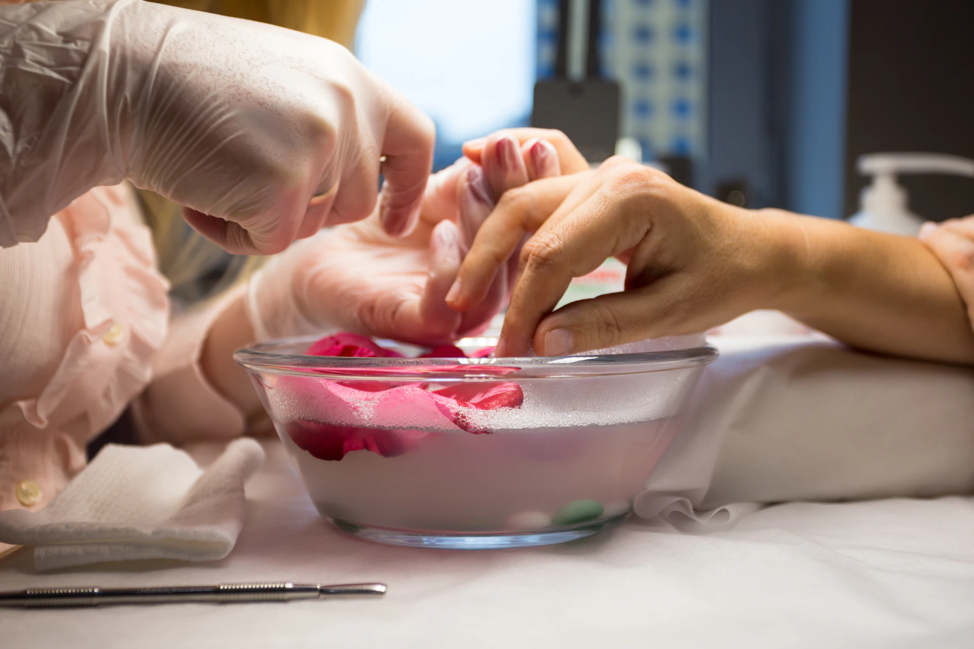 person holding clear glass bowl with red liquid