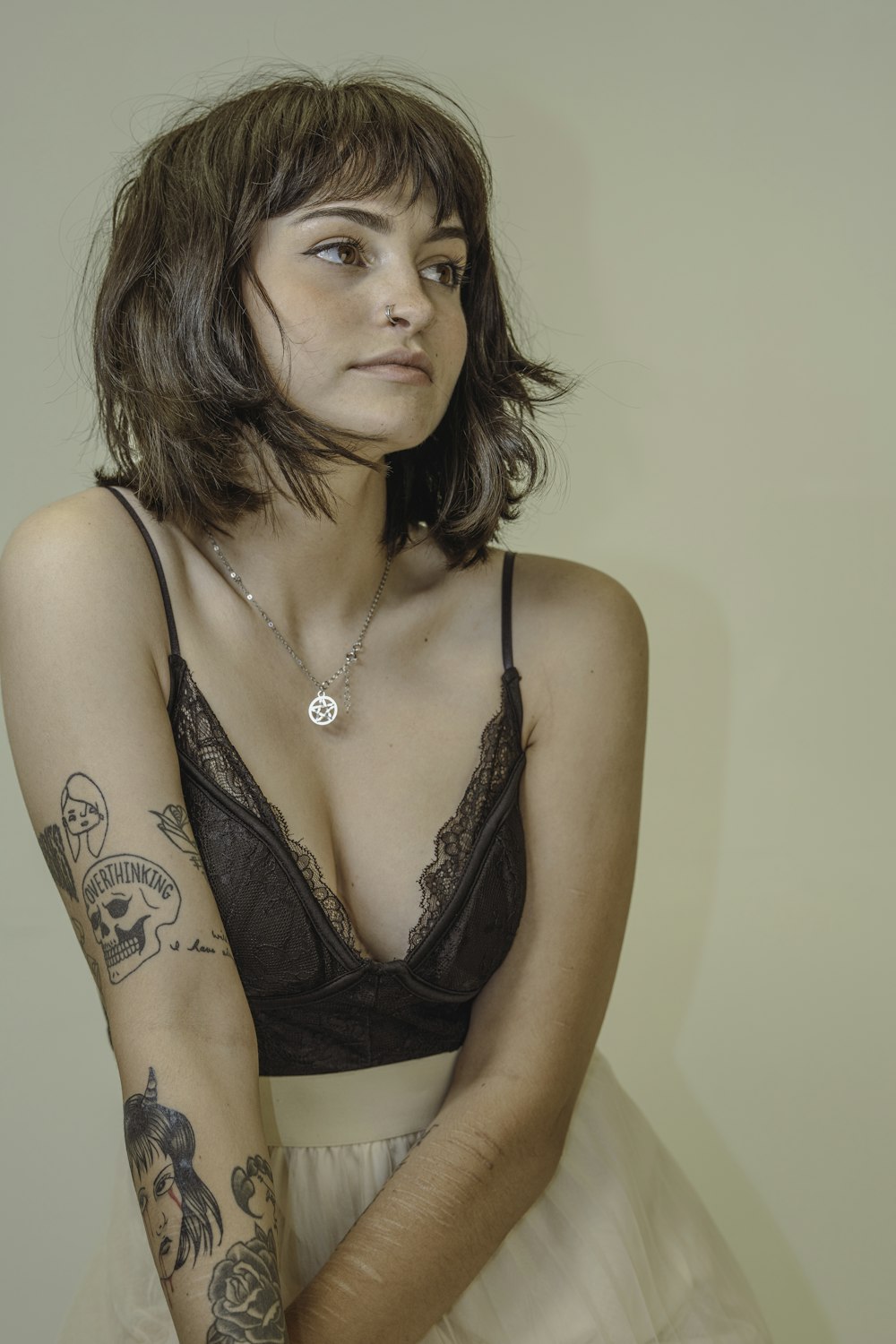 woman in black brassiere with tattoo on chest