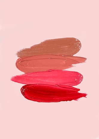An artist's palette with lipstick swatches in different hues.