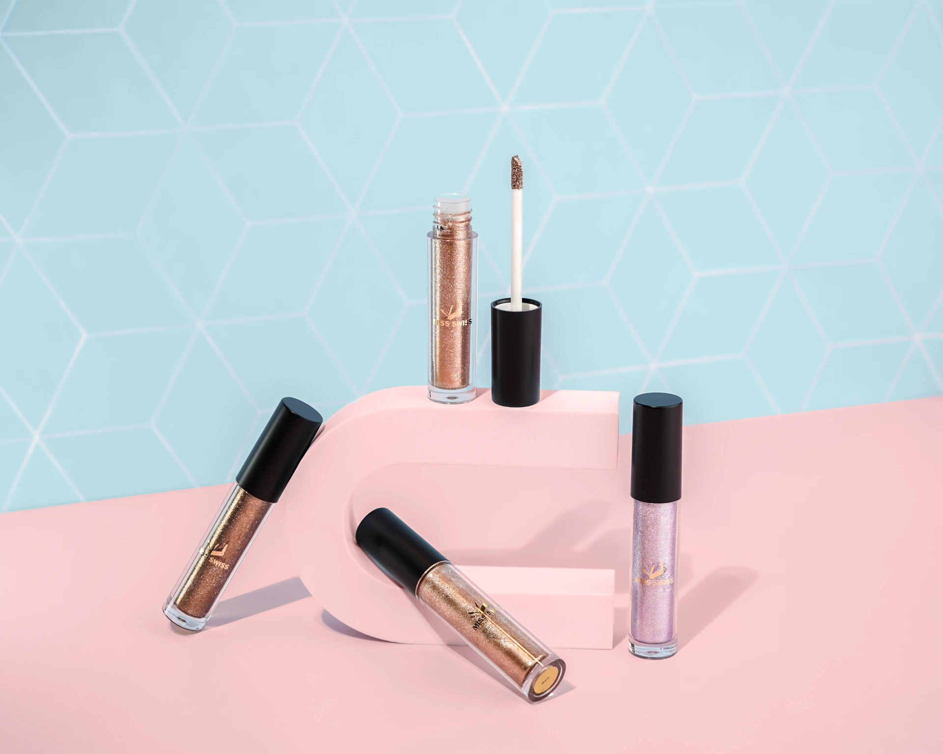 pink and black lipstick on pink and white checkered table