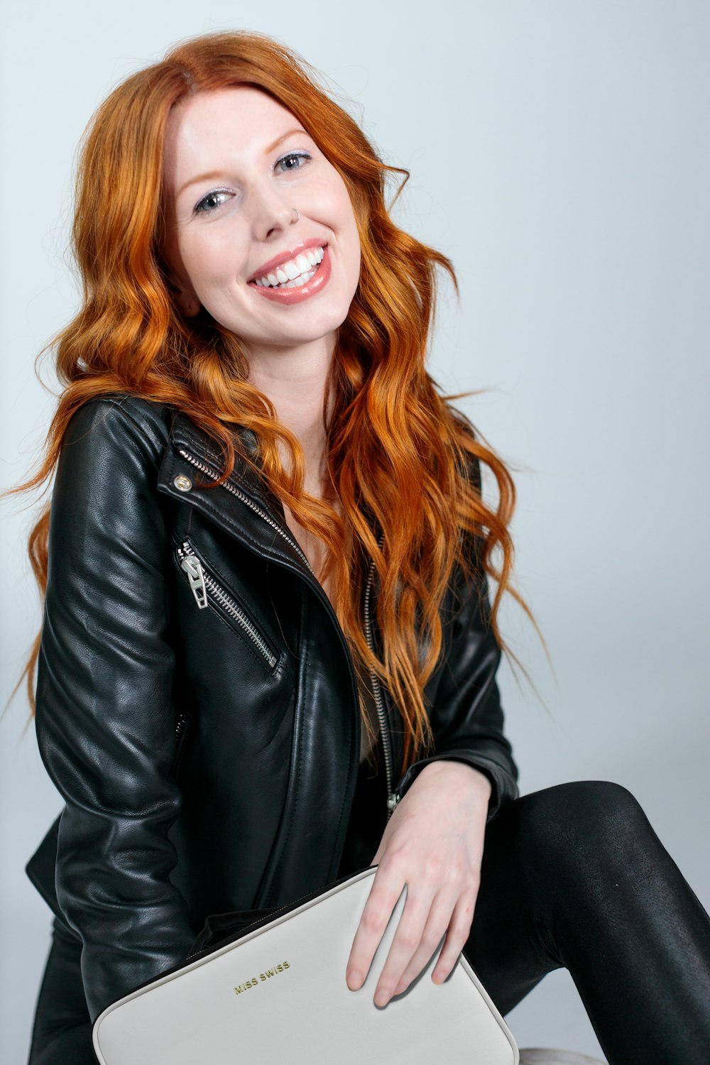 woman in black leather jacket smiling