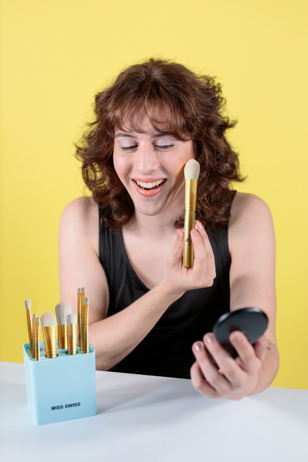 woman in black tank top smiling