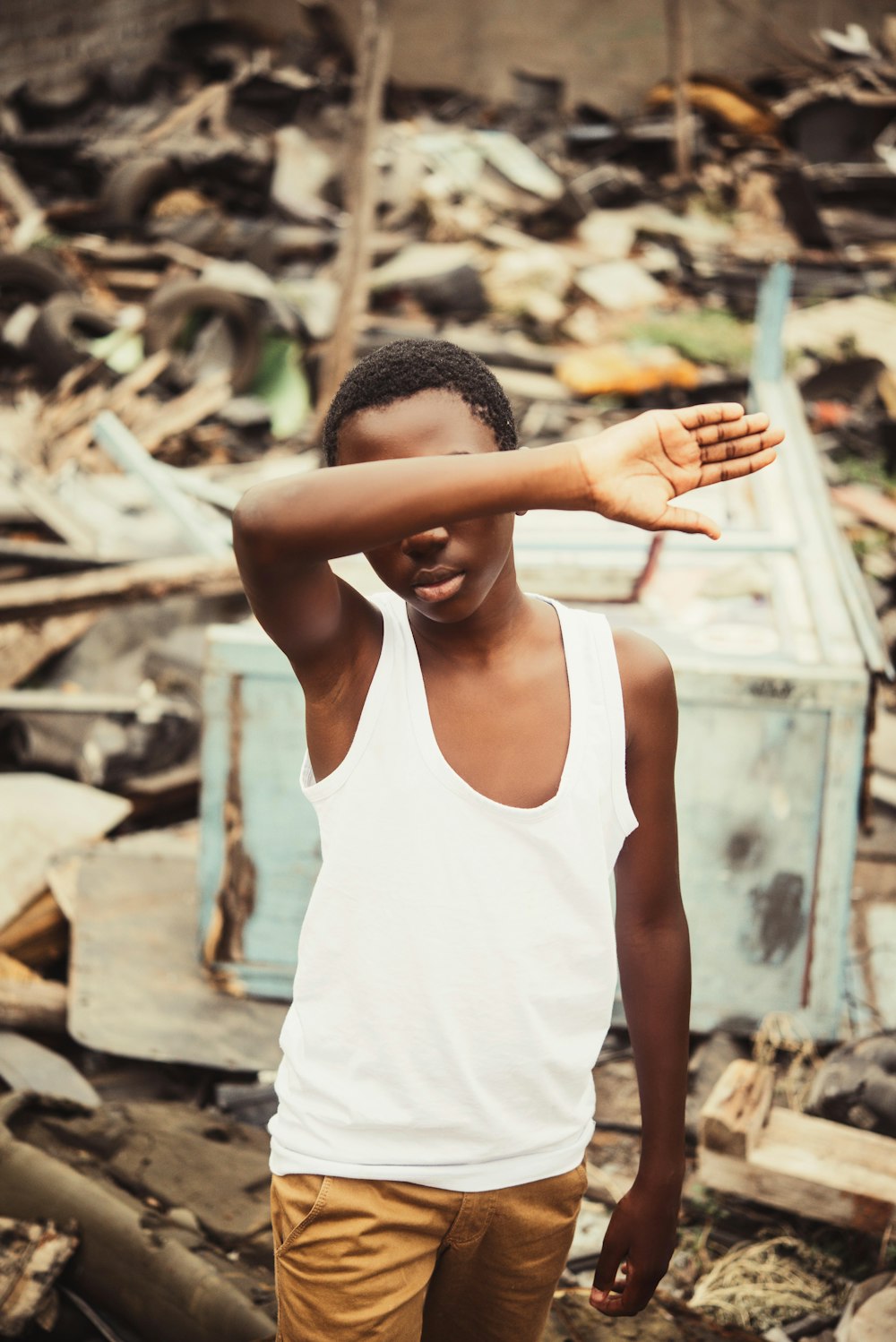 woman in white tank top standing on brown dried leaves during daytime