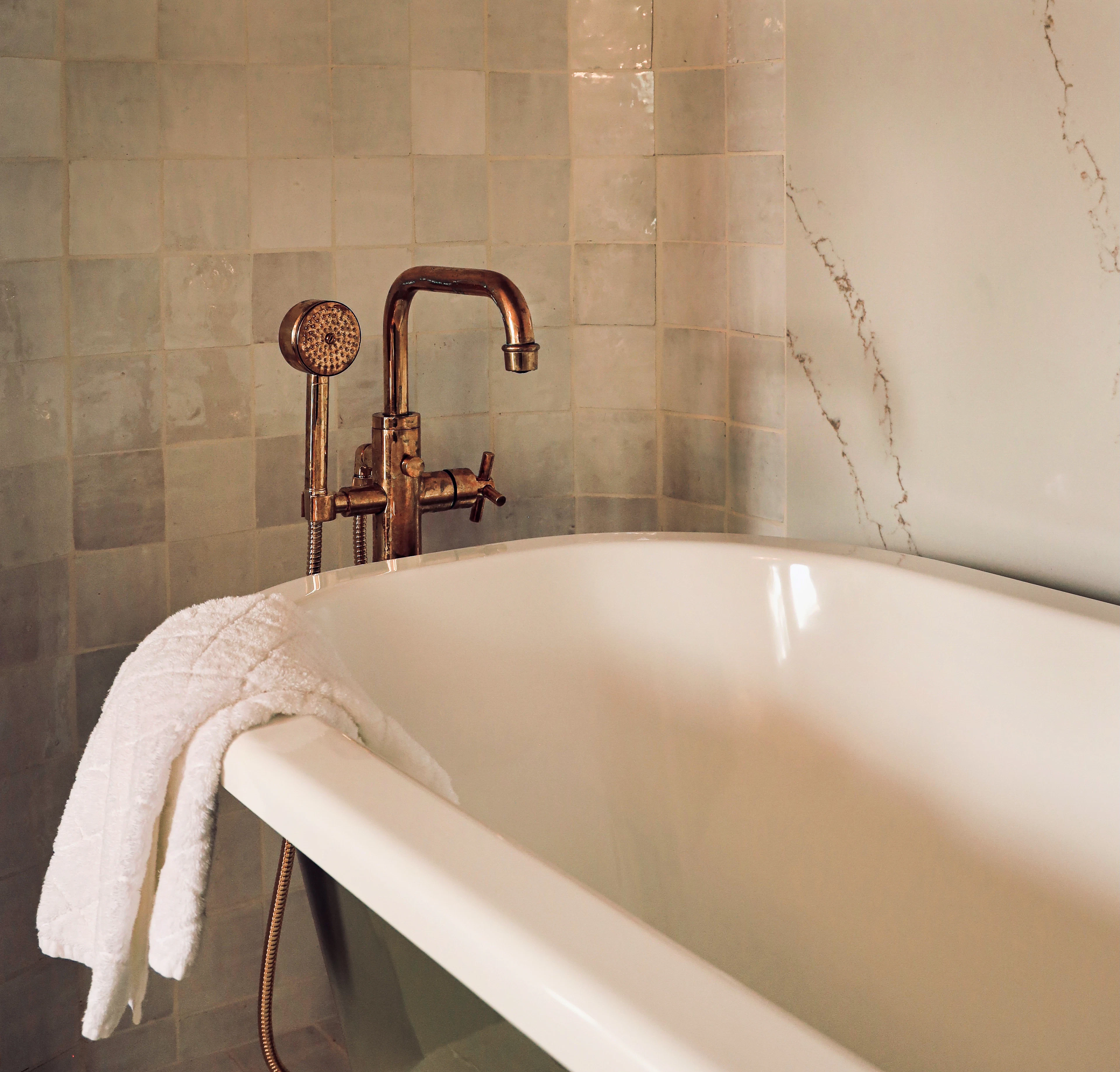 Clawfoot tub with a copper tub filler