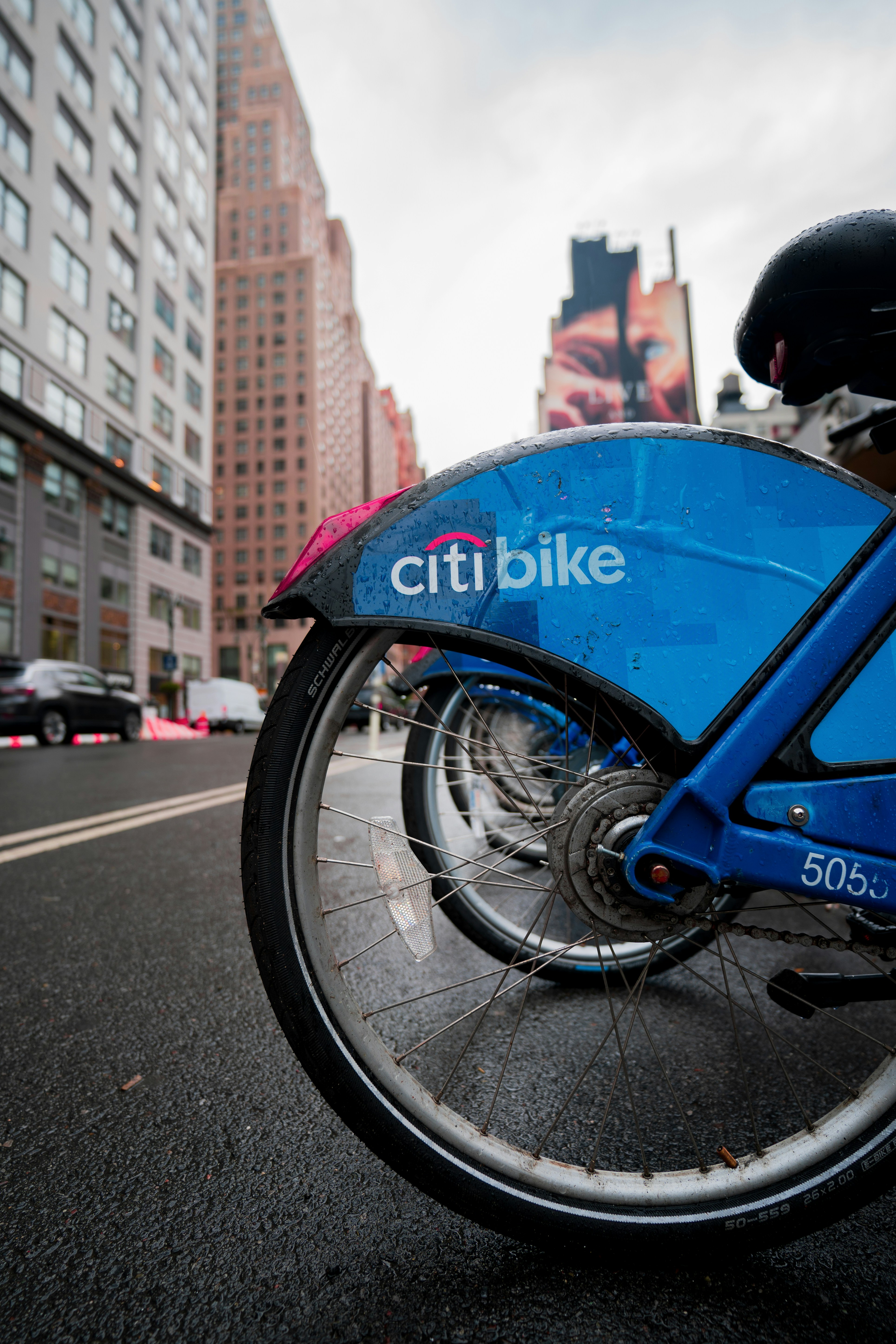 blue bicycle with pink umbrella on the road during daytime