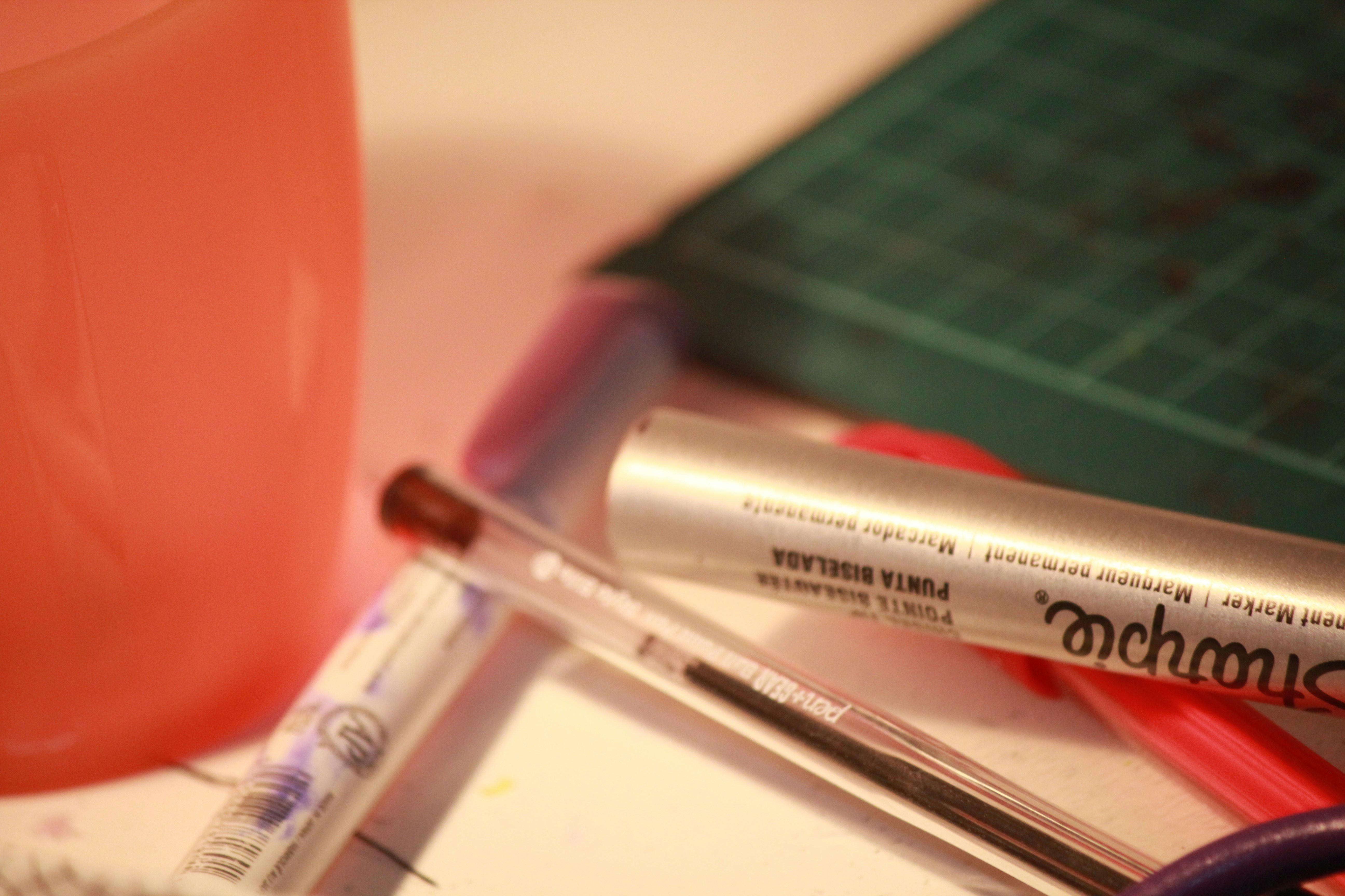 white and black pen on white table