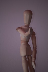 brown wooden human figure on white surface