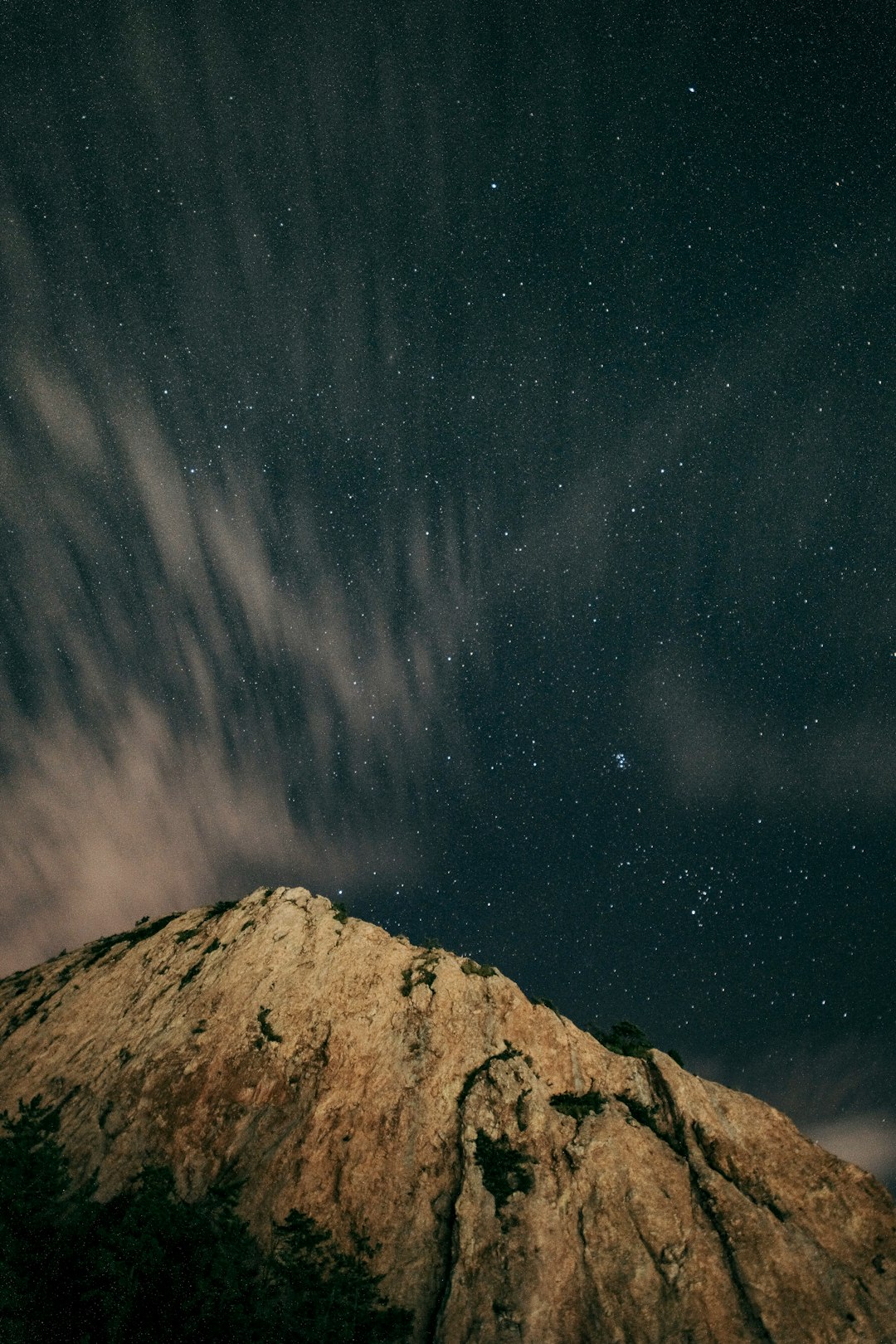 brown rocky mountain under starry night