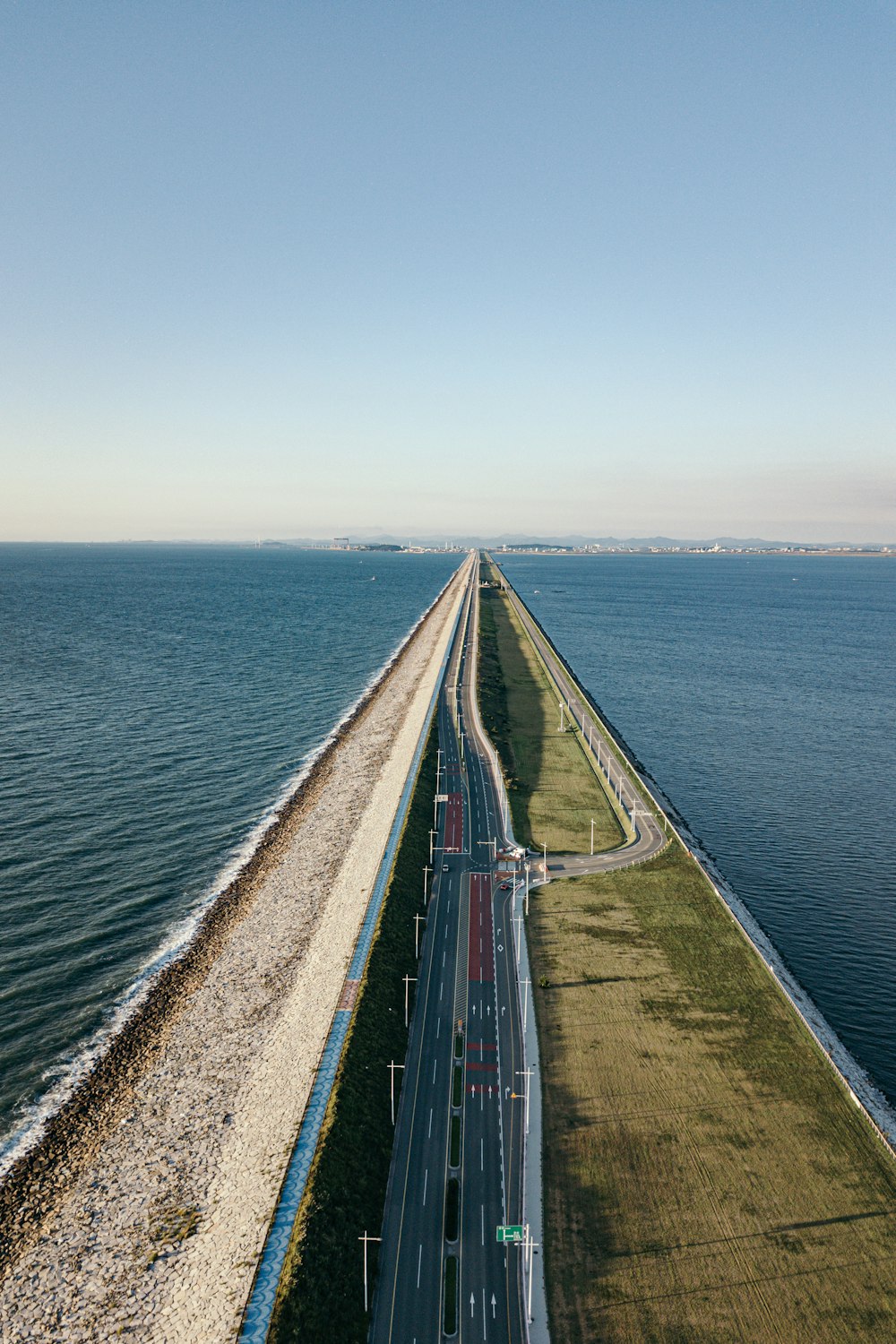an aerial view of a highway next to the ocean