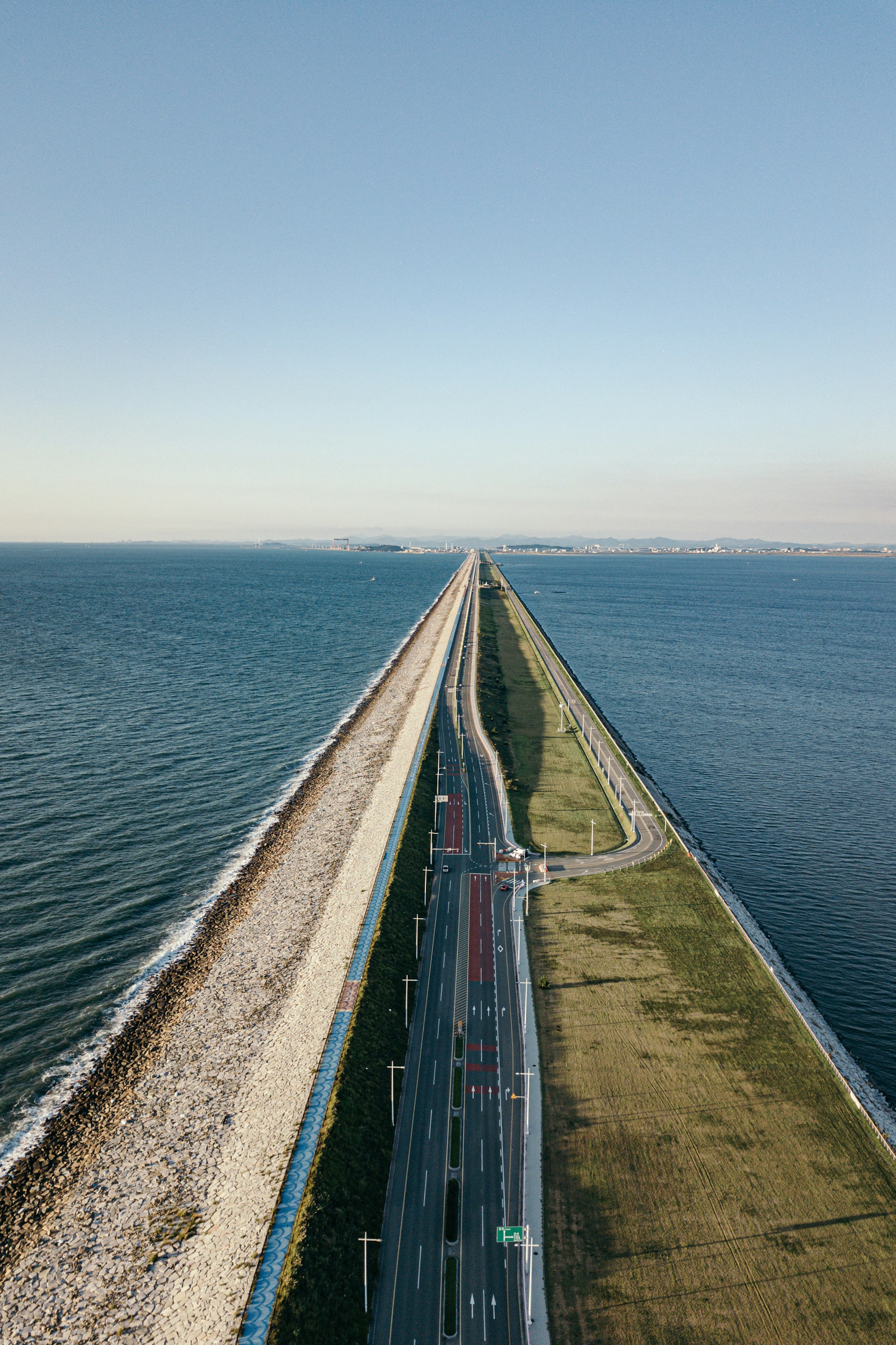 an aerial view of a highway next to the ocean