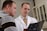 man in white dress shirt holding black tablet computer