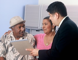 Financial consultant advising a couple, showcasing personalized financial services at Audit Housing 