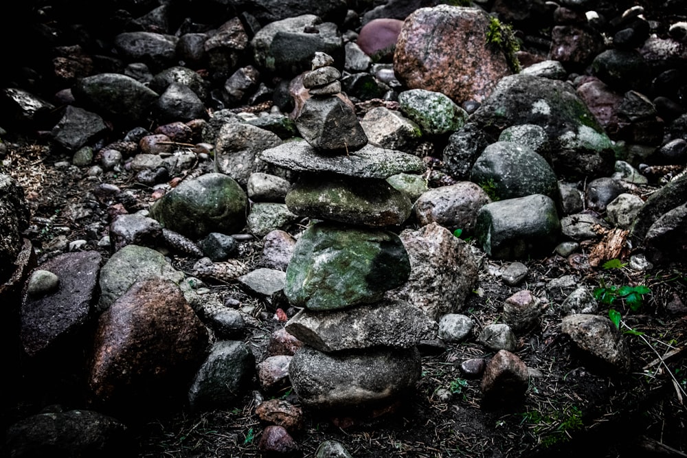 a pile of rocks sitting on top of a dirt field