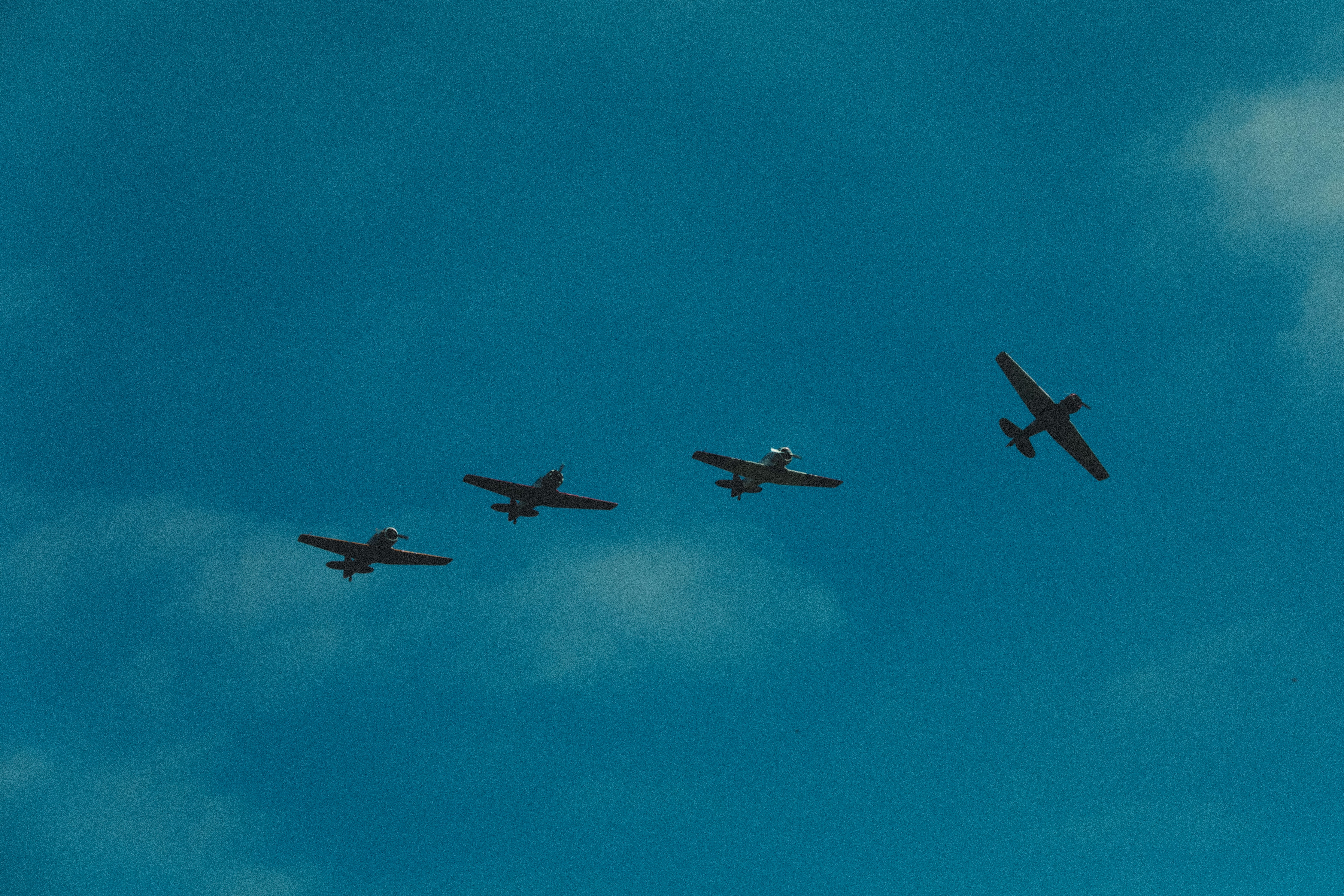Four fighter planes in mid air under blue sky during daytime photo
