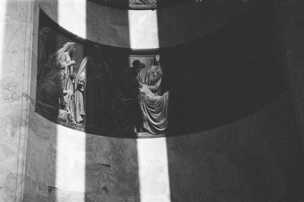 a black and white photo of some statues