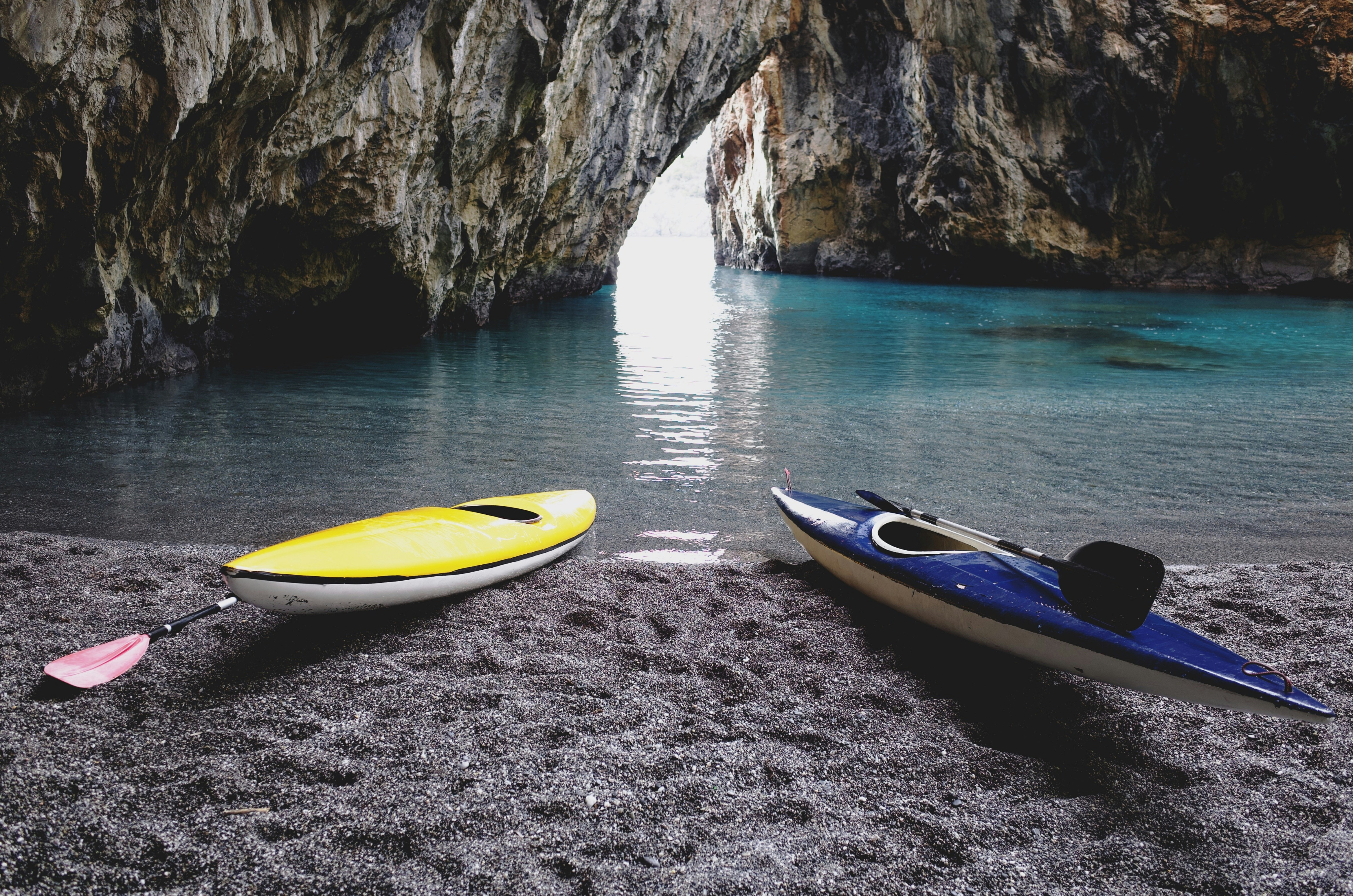 yellow and white kayak on gray sand, 