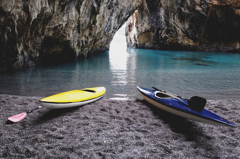 yellow and white kayak on gray sand