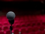 a microphone on a stand in front of a red background